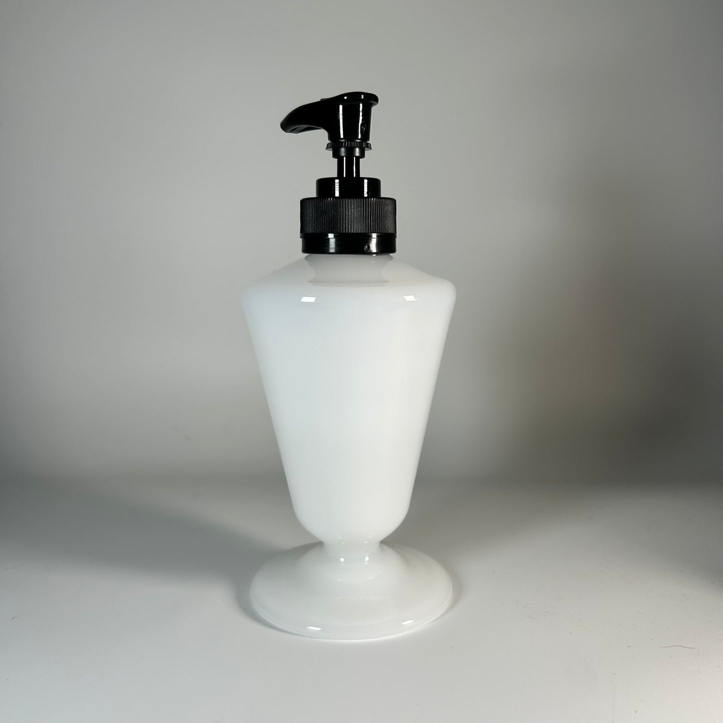 opaque white soap dispenser