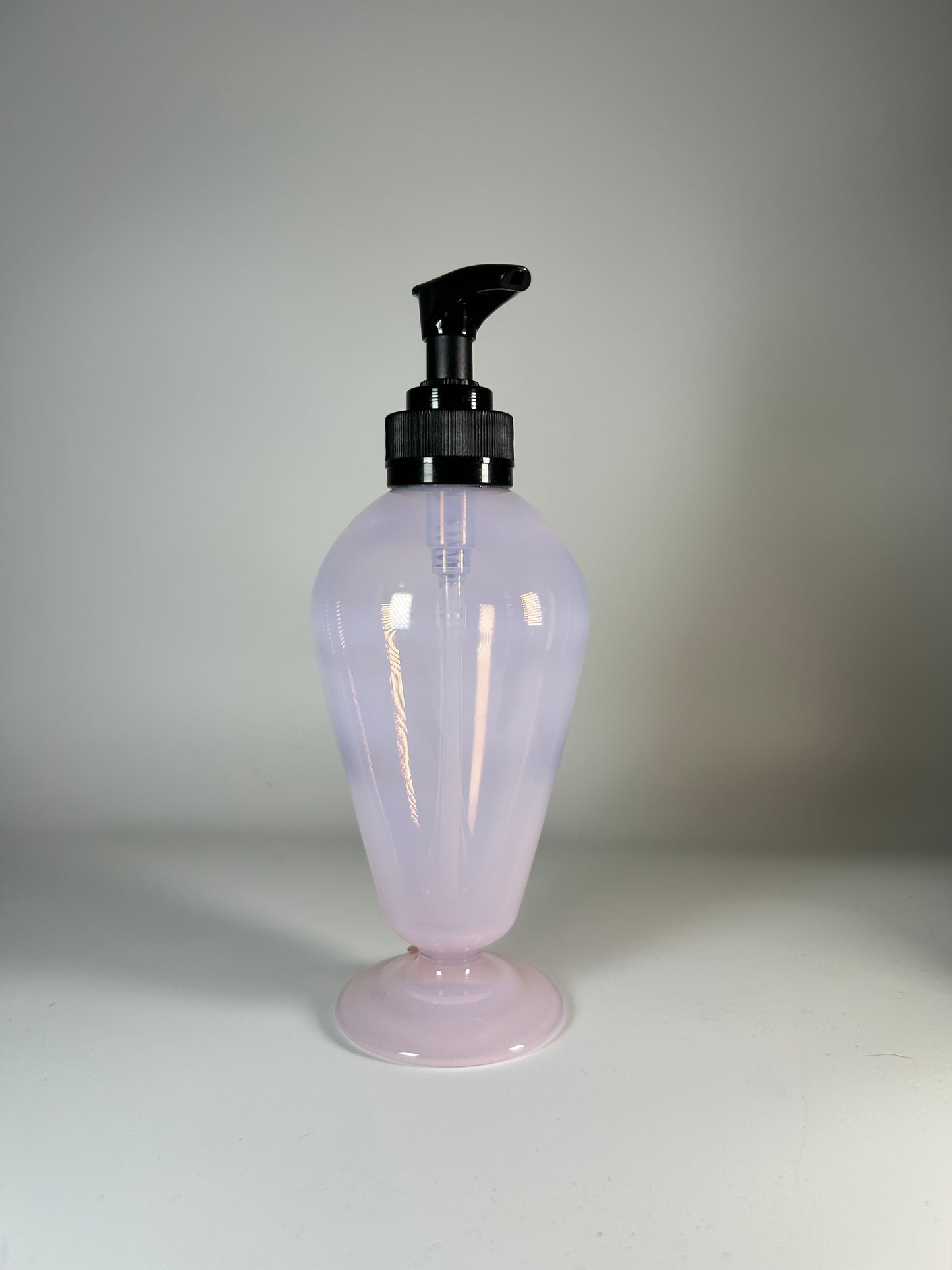 transparent pink soap dispenser