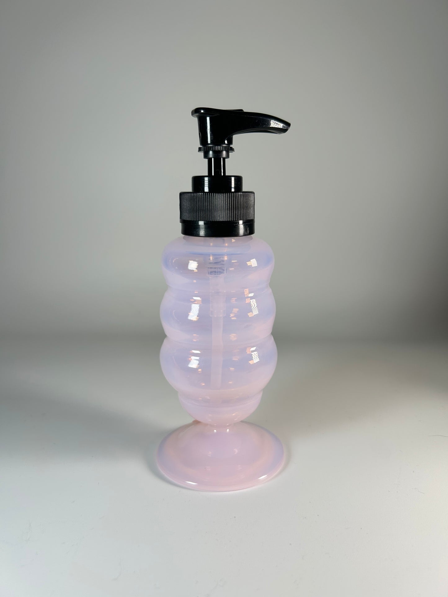 small pink soap dispenser