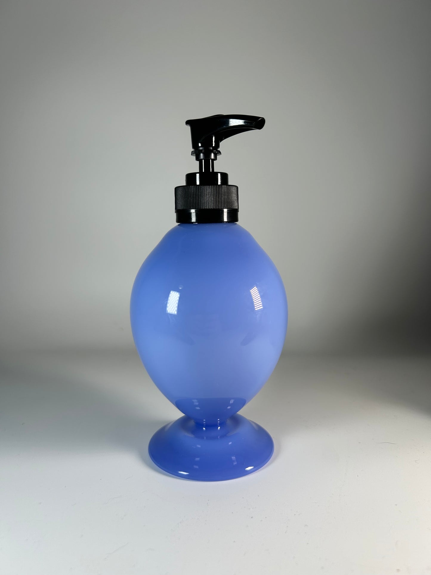 milky blue soap dispenser