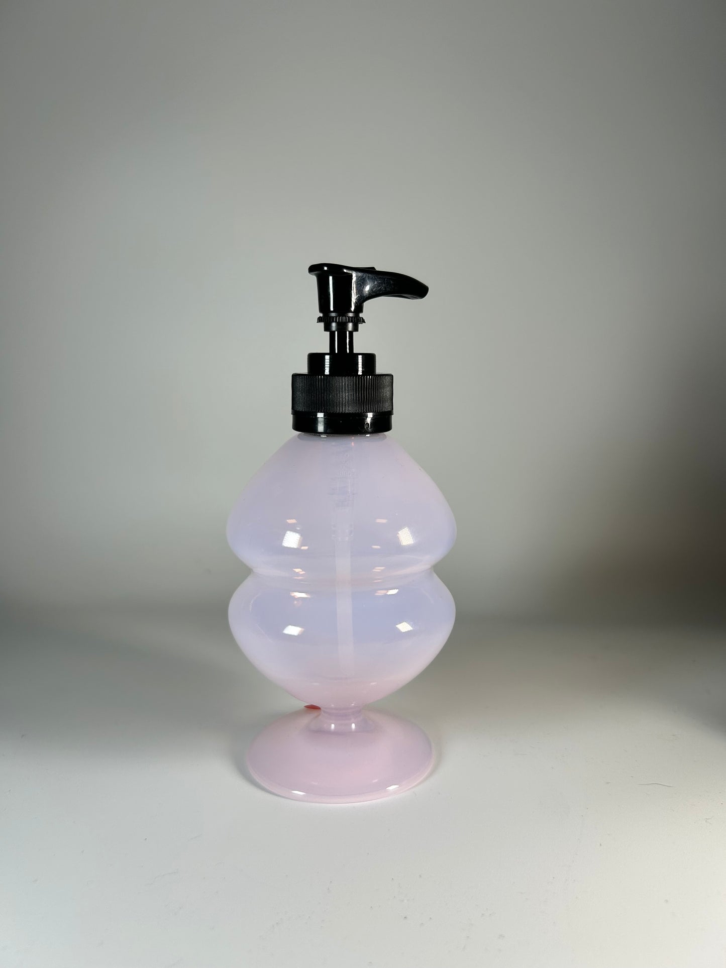 transparent pink soap dispenser